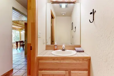 a bathroom with a sink and a mirror at Hot Tub Hideaway in Dorrington