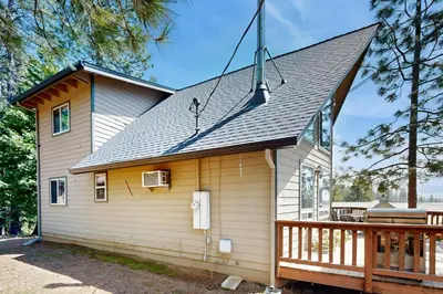 a small house with a porch and a roof at Cozy Chalet in Arnold