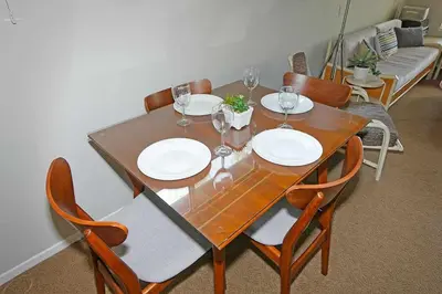 a dining room table with plates and wine glasses on it at Ala Wai BoulevardApartment 23 in Lake Valley