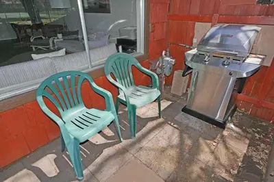 two green chairs sitting outside of a building at Ala Wai BoulevardApartment 23 in Lake Valley