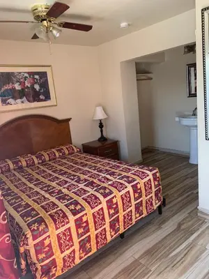 a bedroom with a bed and a ceiling fan at Jerry's Motel in Oakdale