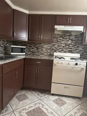 a kitchen with brown cabinets and a white stove at Jerry's Motel in Oakdale