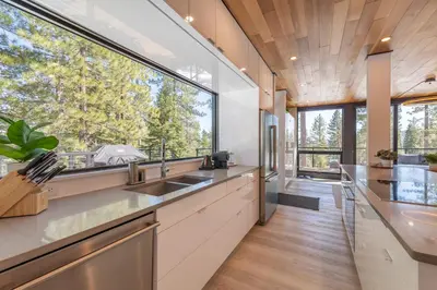 a kitchen with a large window and a sink at Modern Eco Retreat with Hot Tub and Views in Truckee