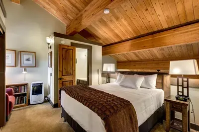 a bedroom with a large bed with a wooden ceiling at Lofted Retreat in The Village! condo in Truckee