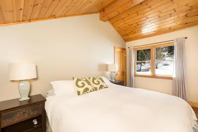 a bedroom with a white bed and a window at Mineral Springs 3 BR w Hot tub Available in Alpine Meadows in Olympic Valley