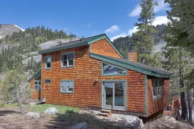 a house on a hill in the woods at Mineral Springs 3 BR w Hot tub Available in Alpine Meadows in Olympic Valley