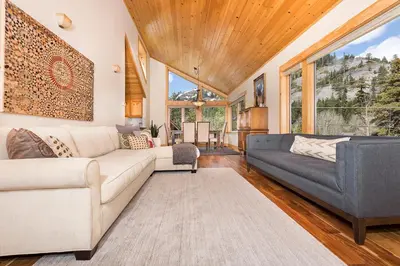 a living room with a couch and a table at Mineral Springs 3 BR w Hot tub Available in Alpine Meadows in Olympic Valley