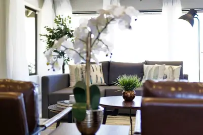 a living room with a couch and a table with white flowers at Oakridge Ranch ※ Sequoia, Kern River & Lake Escape in Lake Isabella