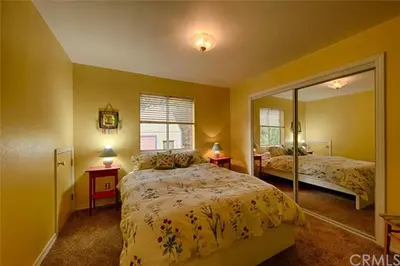 a bedroom with two beds and a mirror at Suite Sunshine A in Yosemite West