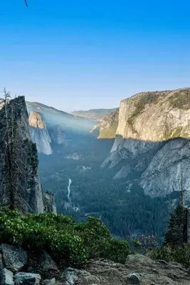 a view of a canyon with a waterfall in the distance at Riverside Manna in Mariposa