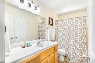 a bathroom with a sink and a shower curtain at Riverside Manna in Mariposa