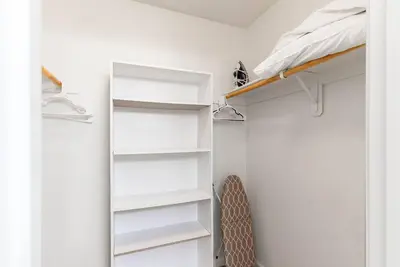 a bedroom with white shelves and a bed at Riverside Manna in Mariposa
