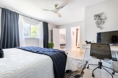 a bedroom with a bed and a ceiling fan at Rolling Oaks Ranch - 200 Acres of Lakeside Beauty & Countryside Serenity in Mariposa