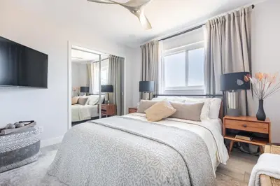 a white bedroom with a bed and a tv at Rolling Oaks Ranch - 200 Acres of Lakeside Beauty & Countryside Serenity in Mariposa