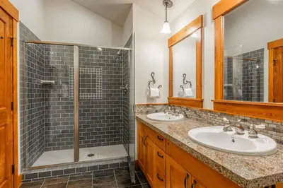 a bathroom with two sinks and a shower at Cabins 24 in Mammoth Lakes