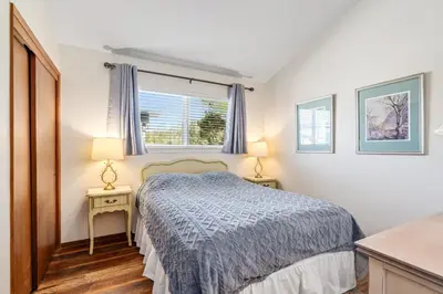 a small bedroom with a bed and two night stands at Kathy's Korner - Pet Friendy with Large Deck! home in Groveland