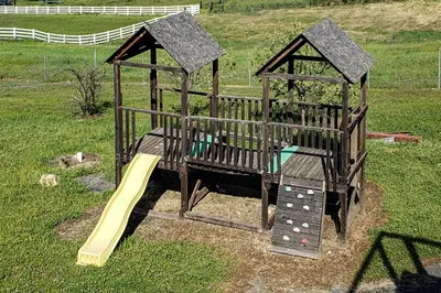 a small playground with a slide and a slideintend at Hot Tub and Expansive Views Copperopolis Mtn Home in Copper Cove Subdivision