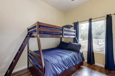 a bedroom with a bunk bed and a window at Hot Tub and Expansive Views Copperopolis Mtn Home in Copper Cove Subdivision