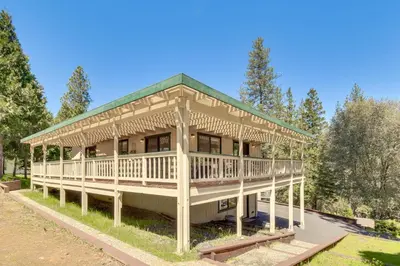 a large wooden house with a green roof at Cozy Cabin in Pine Mountain Lake Near Yosemite! in Groveland