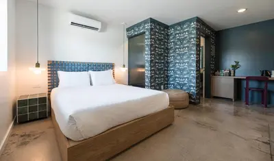 a bedroom with a large bed and a bathroom at Best Bet Motor Lodge in Reno