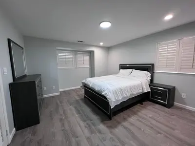 a bedroom with a bed and a dresser in it at Entire 3 BR & 2 BA house for business and family in Modesto