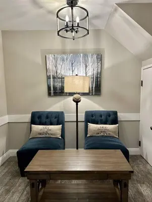 a living room with two chairs and a table at Rustic Modern Condo - Close to Village - Sleeps 10 in Mammoth Lakes