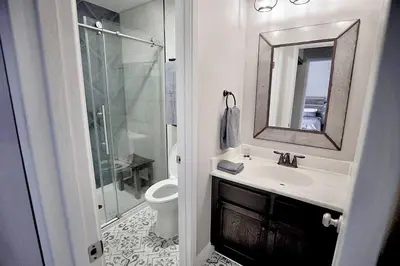 a bathroom with a toilet and a sink and a mirror at Rustic Modern Condo - Close to Village - Sleeps 10 in Mammoth Lakes