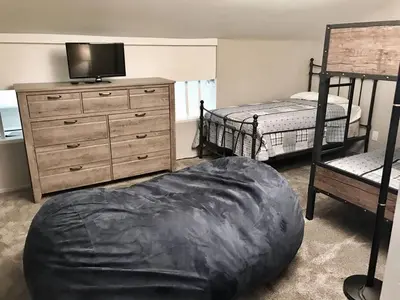 a bedroom with two beds and a bean bag chair at Rustic Modern Condo - Close to Village - Sleeps 10 in Mammoth Lakes