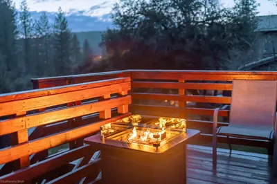 a fire pit on a deck with a chair at Mountain View, near Yosemite & Bass Lake, BBQ, Fireplace,EVC in Oakhurst