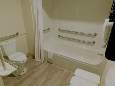 a bathroom with a toilet and a bath tub at Travelodge by Wyndham Angels Camp CA in Angels Camp