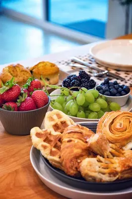 a table topped with plates of pastries and fruit at Horizon by Yosemite in Midpines