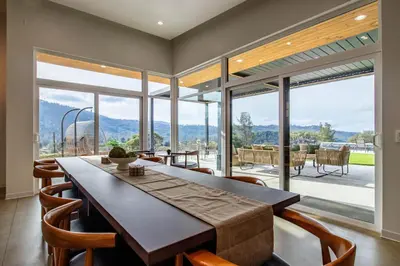 a dining room with a table and a large window at Horizon by Yosemite in Midpines