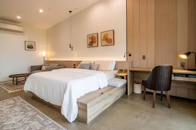 a bedroom with a bed and a desk and a chair at Horizon by Yosemite in Midpines