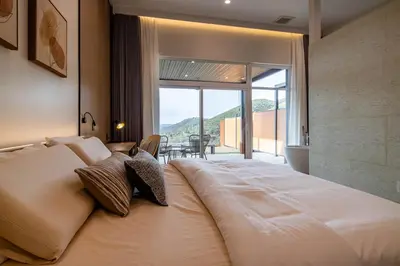 a large bed in a room with a large window at Horizon by Yosemite in Midpines
