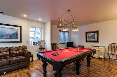 a living room with a pool table and a couch at Spring Wonderland in Yosemite West