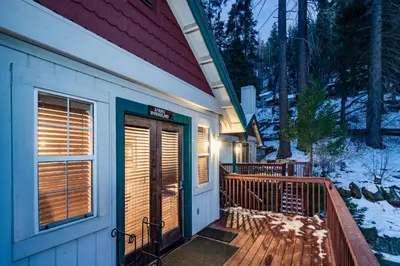 a front door of a house with snow on the ground at Spring Wonderland in Yosemite West