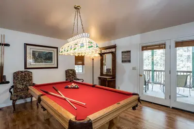 a room with a pool table and a chandelier at Lower Cascades in Yosemite West