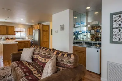 a living room with a couch and a kitchen at Lower Cascades in Yosemite West