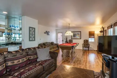 a living room with couches and a ping pong table at Lower Cascades in Yosemite West