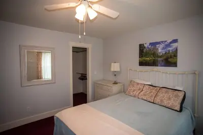 a bedroom with a bed and a ceiling fan at Yosemite Firehouse Inn in Mariposa