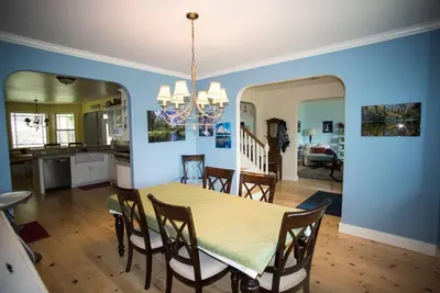 a dining room and kitchen with a table and chairs at Yosemite Firehouse Inn in Mariposa