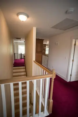 a staircase in a house with purple carpet at Yosemite Firehouse Inn in Mariposa