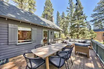 a deck with a wooden table and chairs at Cozy Designer Decorated Cabin Near Slopes Fireplace Peekaboo Lakeview in Carnelian Bay