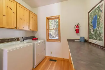 a laundry room with a washing machine and a window at Cozy Designer Decorated Cabin Near Slopes Fireplace Peekaboo Lakeview in Carnelian Bay