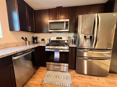 a kitchen with stainless steel appliances and wooden cabinets at Sunrise View in Rocklin