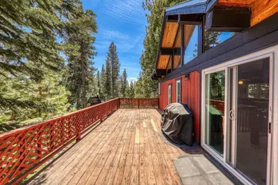 a wooden walkway to a red house with trees at Carnelian Bay 4BD Near Beach & Slopes in Carnelian Bay
