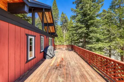 a red house with a deck in the woods at Carnelian Bay 4BD Near Beach & Slopes in Carnelian Bay