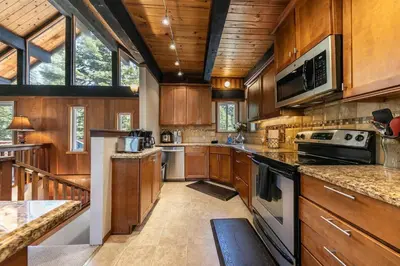 a large kitchen with wooden cabinets and appliances at Carnelian Bay 4BD Near Beach & Slopes in Carnelian Bay