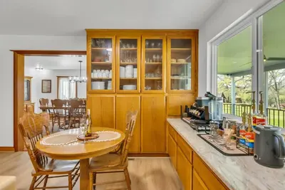 a kitchen with a wooden counter and a table at Lakeside Vineyard Retreat - Deaver's Winery in Plymouth