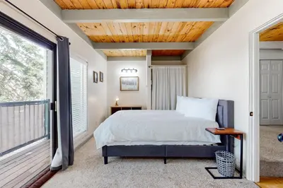 a bedroom with a bed and a large window at Tahoe Heavenly Hideaway in Stateline